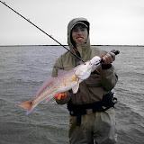 Larry with a nice red caught on a Corky.  This was right before the rain on Saturday.  Wind was about 30+mph &amp; we were one of about 5 idiots actually on the water!
