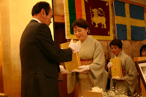 Dhamma Society Chancellor receiving the Roman-script Tipitaka from Japanese Patron. 
