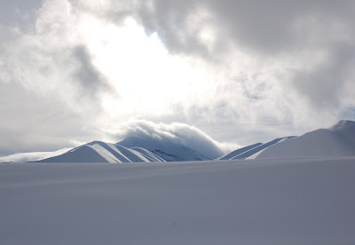 Clouds clinging to hills in white landscape. Hailey, ID.