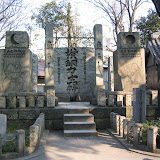 Stones commemorating successive generations of sumo champions, at Tomioka Hachiman shrine