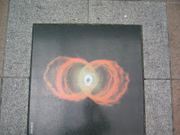 The road in Tenmonkan has a number of tiles depicting astronomical phenomena. This is a favorite of mine, the Hourglass Nebula