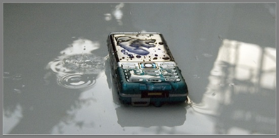 Sony Ericsson splash proof and dust-proof C702 camera phone, almost waterproof. Water on the phone photo
