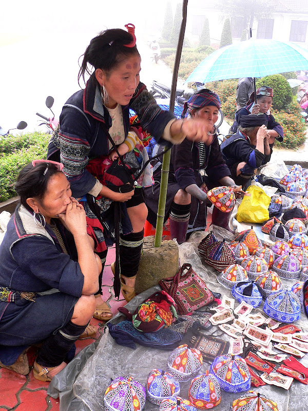 Hmong women, peddling embroidered caps, Sa Pa market