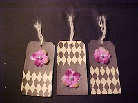 3 of 6 - These tags are covered with scrapbook papers. I have added fabric flower petals with a vintage pearl as the center. Of course, I had to put alittle glitter on it too! Size is 5 1/4" X 2 5/8" and are blank on the back.