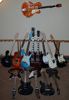 The non-PRS collection as of June 2007... Gretsch G6120-1959 hollowbody; L to R back: Godin SD, G&L ASAT Deluxe semi-hollow, G&L Legacy Standard, Gibson EDS-1275 doubleneck, G&L ASAT Special, G&L ASAT Classic, Ibanez TC-630 Talman; L to R front: Heritage H-535 semi-hollowbody, Voodoo Guitar Works custom archtop, Gibson Firebird V, EB MM John Petrucci 7-string, Ibanez JS1000-BP Joe Satriani model