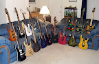 My Ibanez collection as of Oct 2003... L to R back: RG7CT-VV Prestige, UV777-BK Universe, Jem7-VWH, Jem90-HAM, JPM100-P1, JPM90-HAM, RG-ART J-Custom; L to R front: RG1077XL-RB Prestige, RG-PR1 Prestige, RG2680M-DBK Prestige, RG2420-TB Prestige, RGT3120-TV Prestige, RG3120-TW Prestige, USA Custom Exotic Wood, RG1880-BGS J-Custom, RG1680x-AM J-Custom