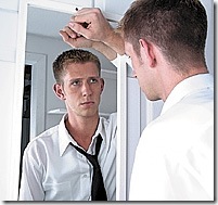 young20man20looking20in20mirror
